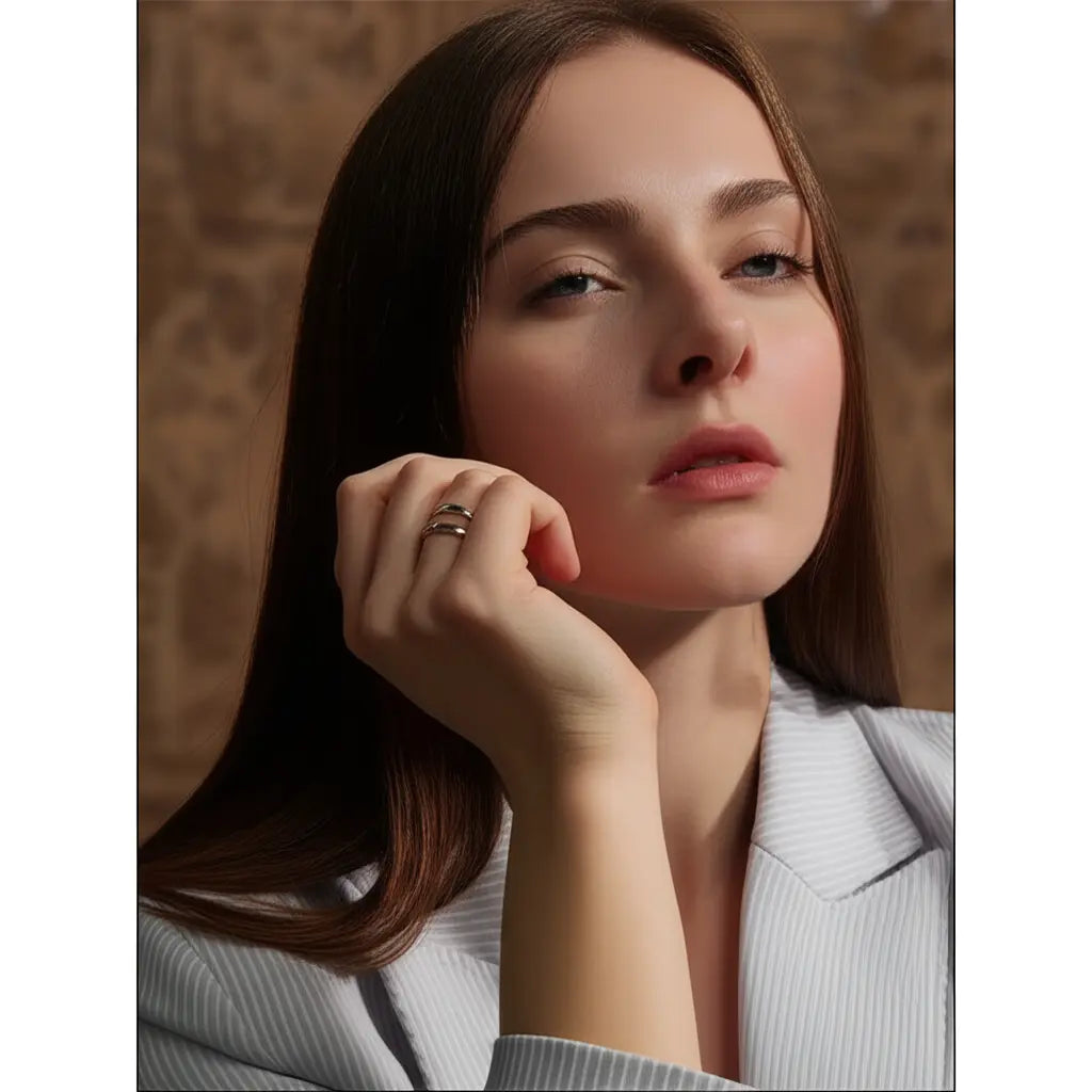 Woman with hand near face against a neutral background