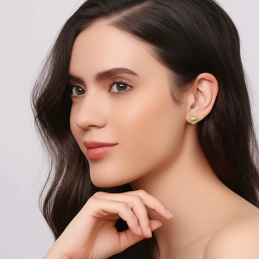 Woman wearing a green earring with a plain background