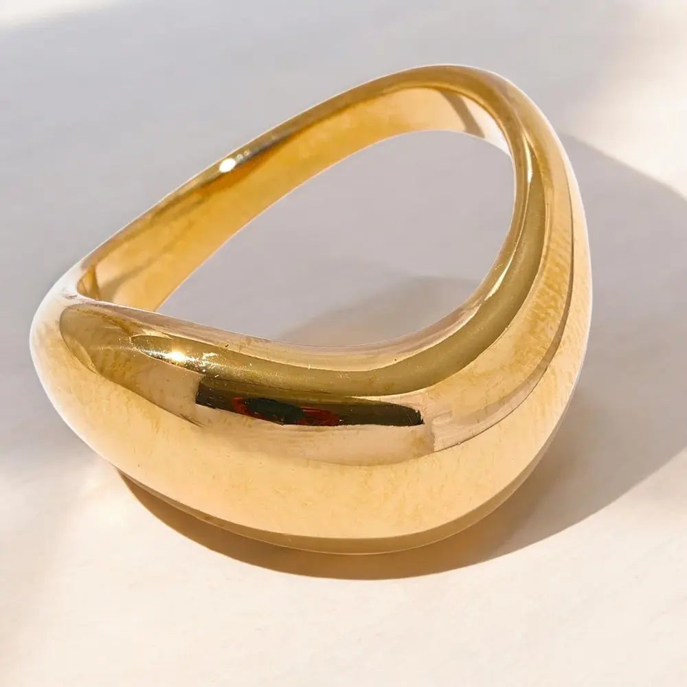 Gold bracelet on a light background