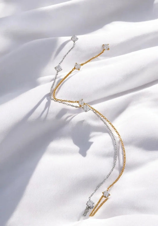 Gold and silver bracelet on a white fabric background