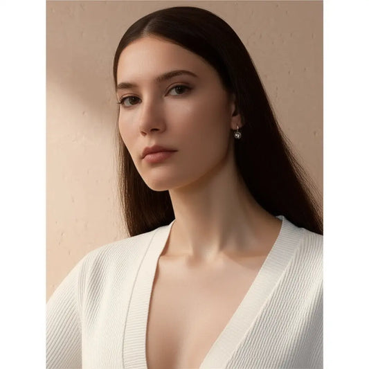 Woman wearing a white top against a beige background