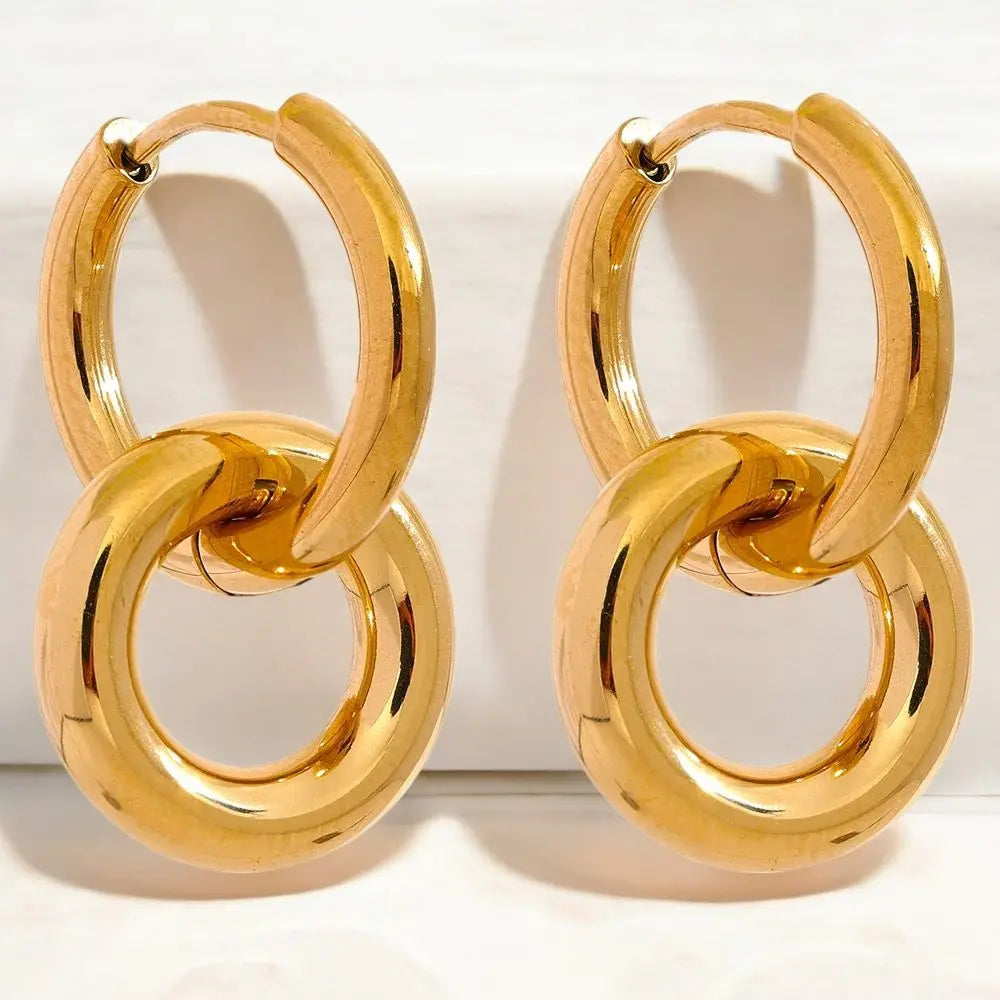 Pair of gold hoop earrings on a white background