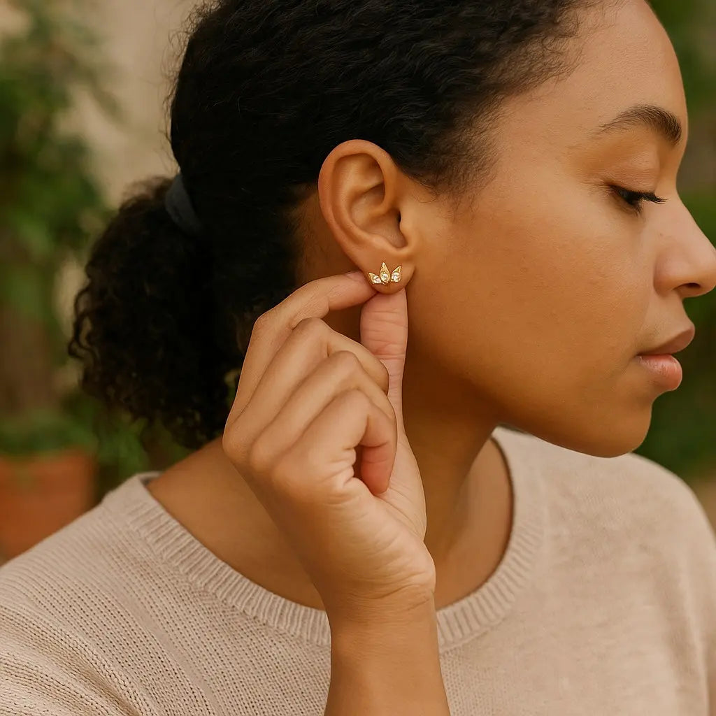 Woman adjusting an earring with a blurred natural background