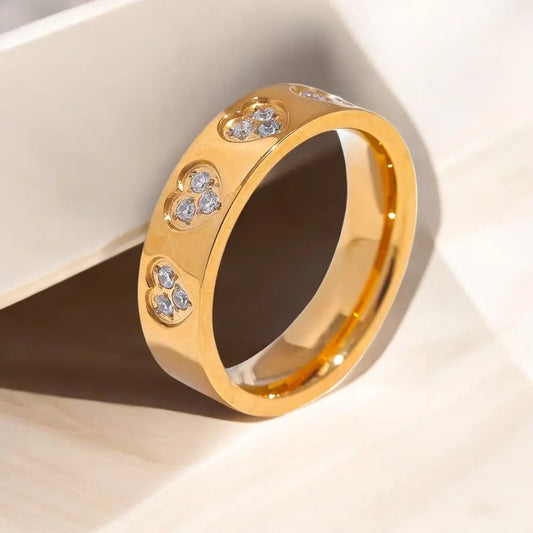 Gold ring with embedded diamonds on a light background