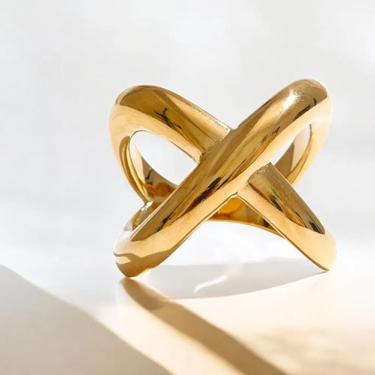 Gold ring with a modern design on a light background