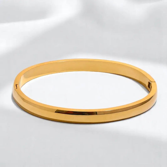 Gold bracelet on a white background