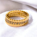 Gold ring with diamond accents on a white background