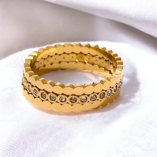 Gold ring with diamond accents on a white background