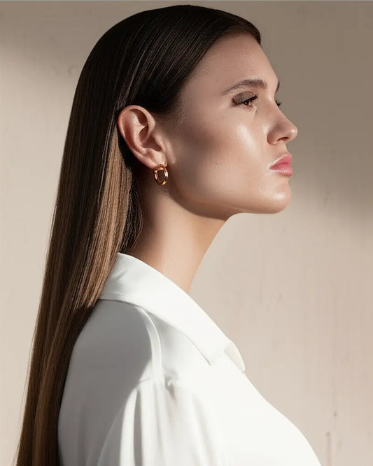 Woman wearing a white shirt with a neutral background