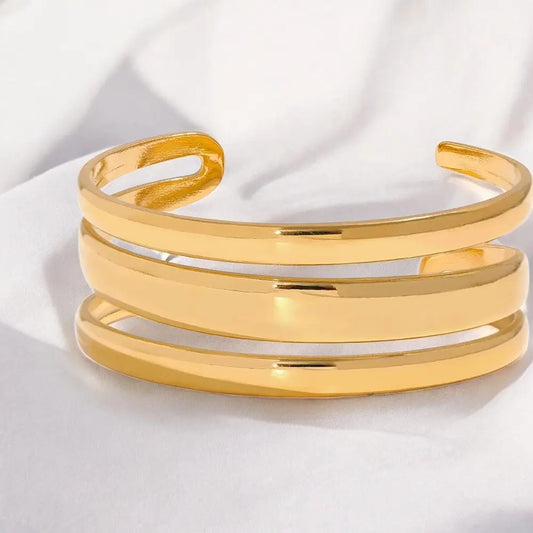 Gold bracelet on a white fabric background
