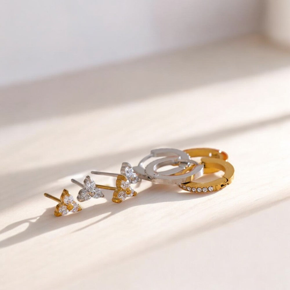 Set of gold and silver hair clips on a light background
