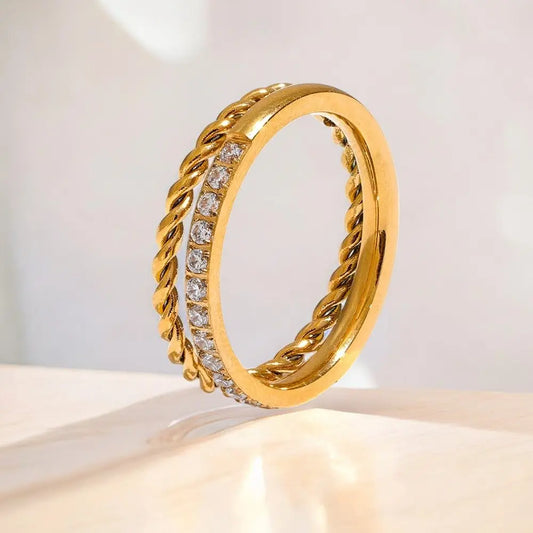 Gold ring with diamond accents on a light background
