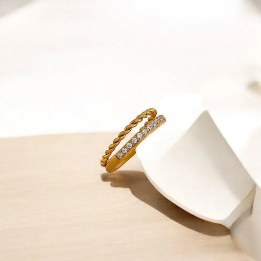 Gold ring with small diamonds on a white surface