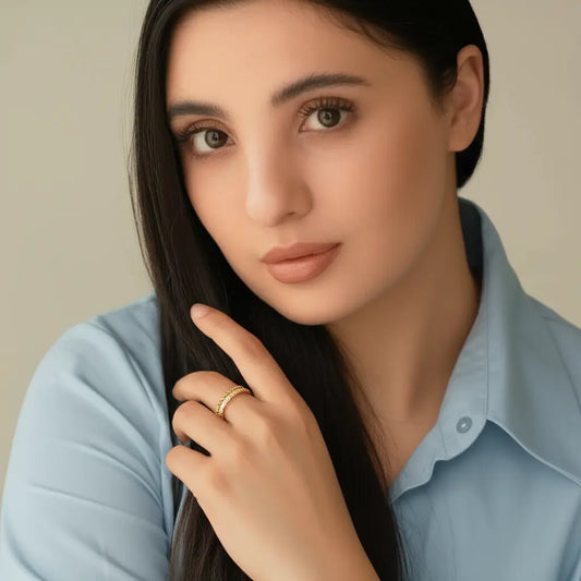 Woman wearing a light blue shirt with a neutral background