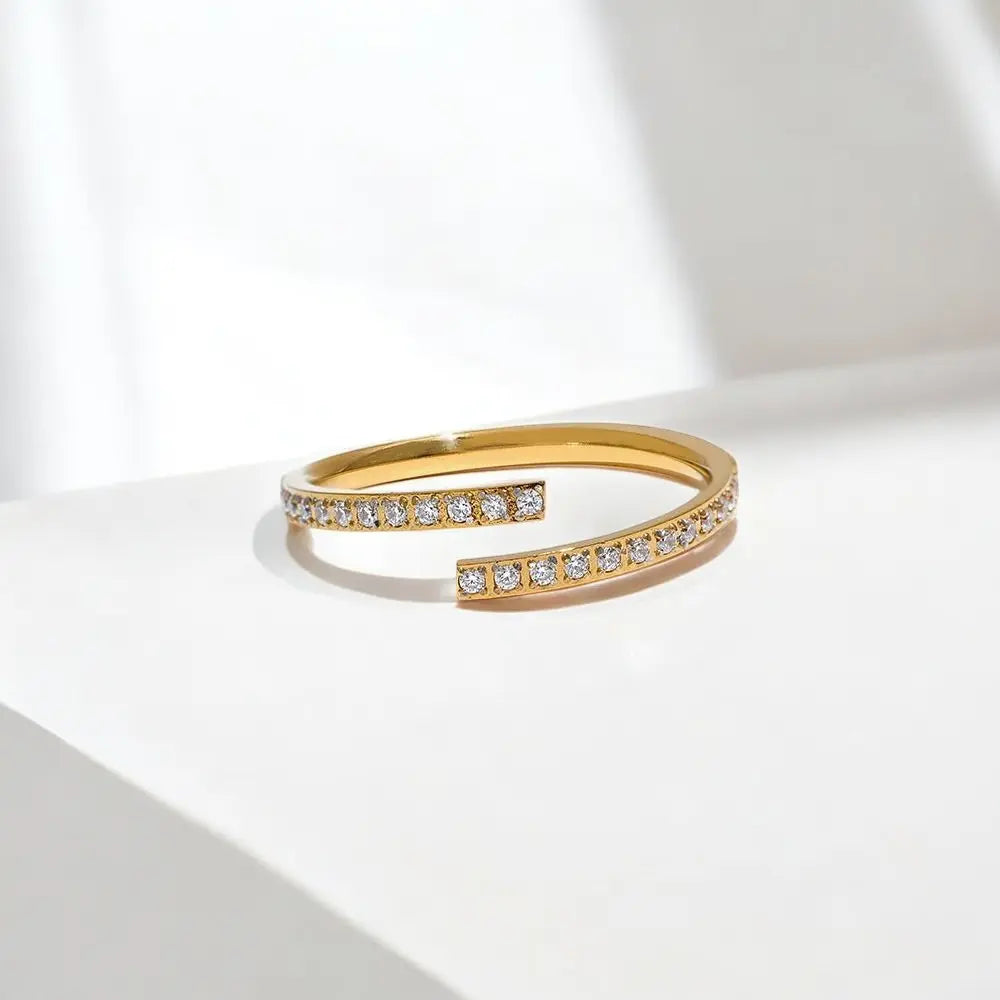 Gold bracelet with embedded crystals on a white background