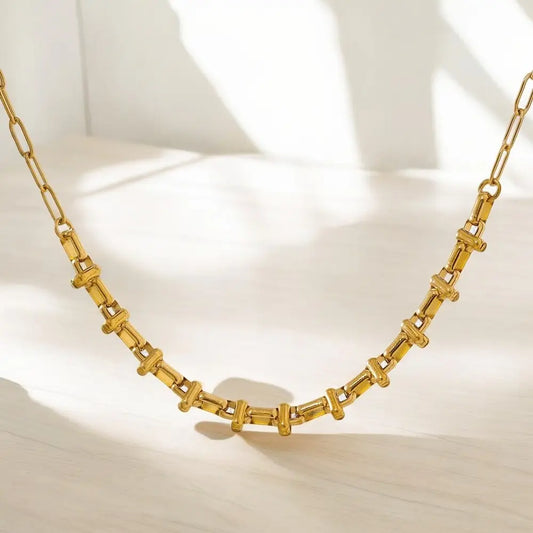 Gold necklace on a light background
