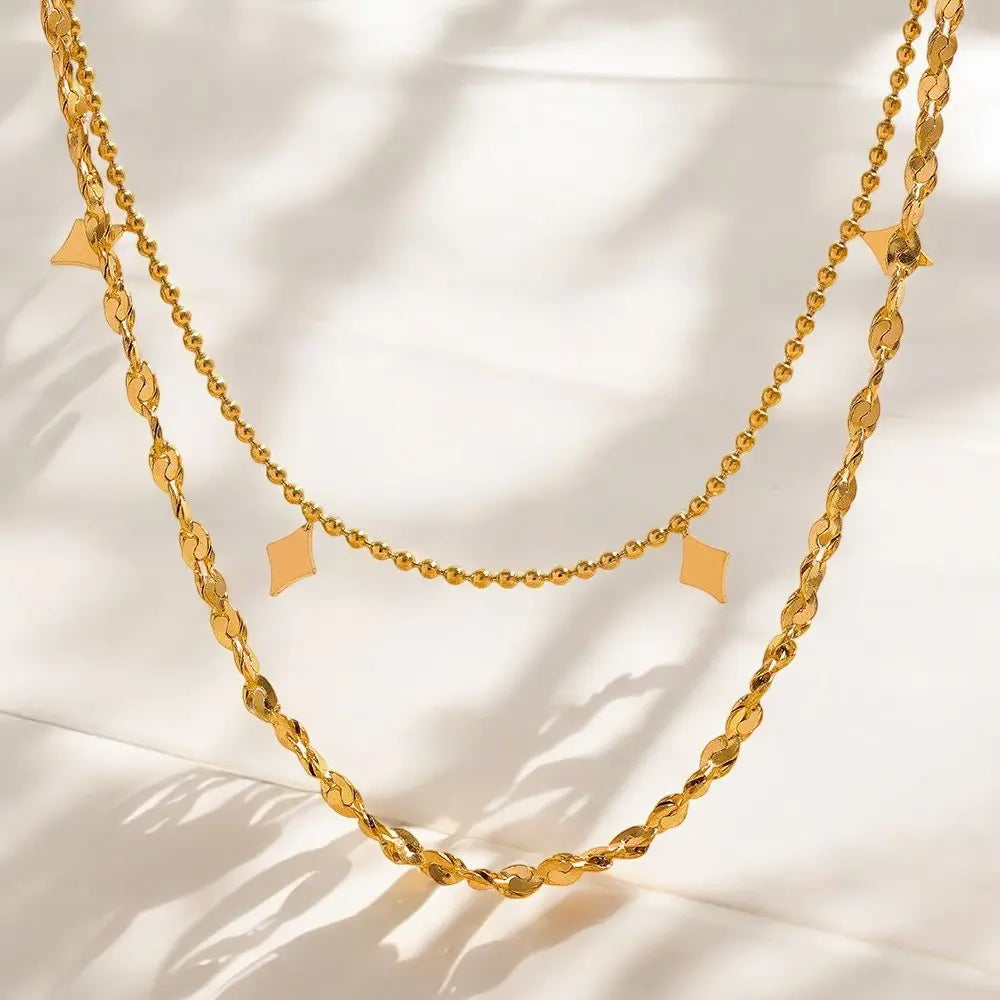 Gold chain necklace on a light background