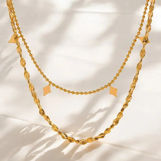 Gold chain necklace on a light background