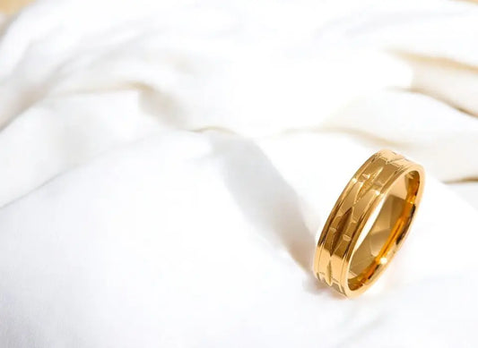 Gold ring on a white fabric background