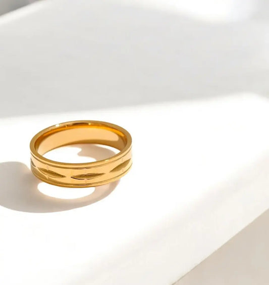 Gold ring on a white surface