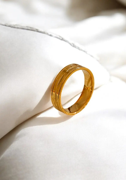 Gold ring on a white fabric background