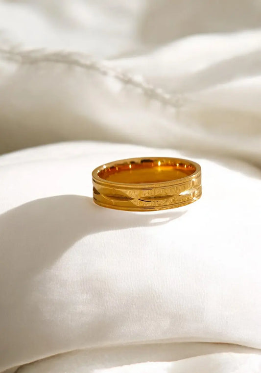 Gold ring on a white fabric background