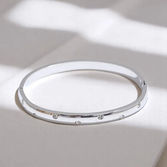 Silver bracelet with small stones on a light background