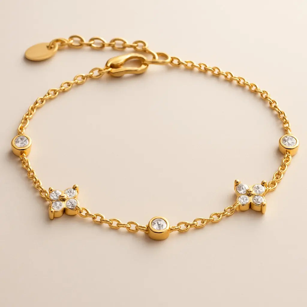 Gold bracelet with diamond-like stones on a beige background