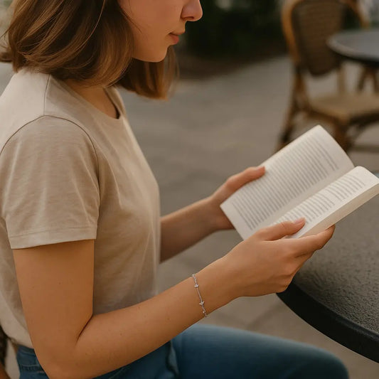 Person reading a book outdoors in a casual setting