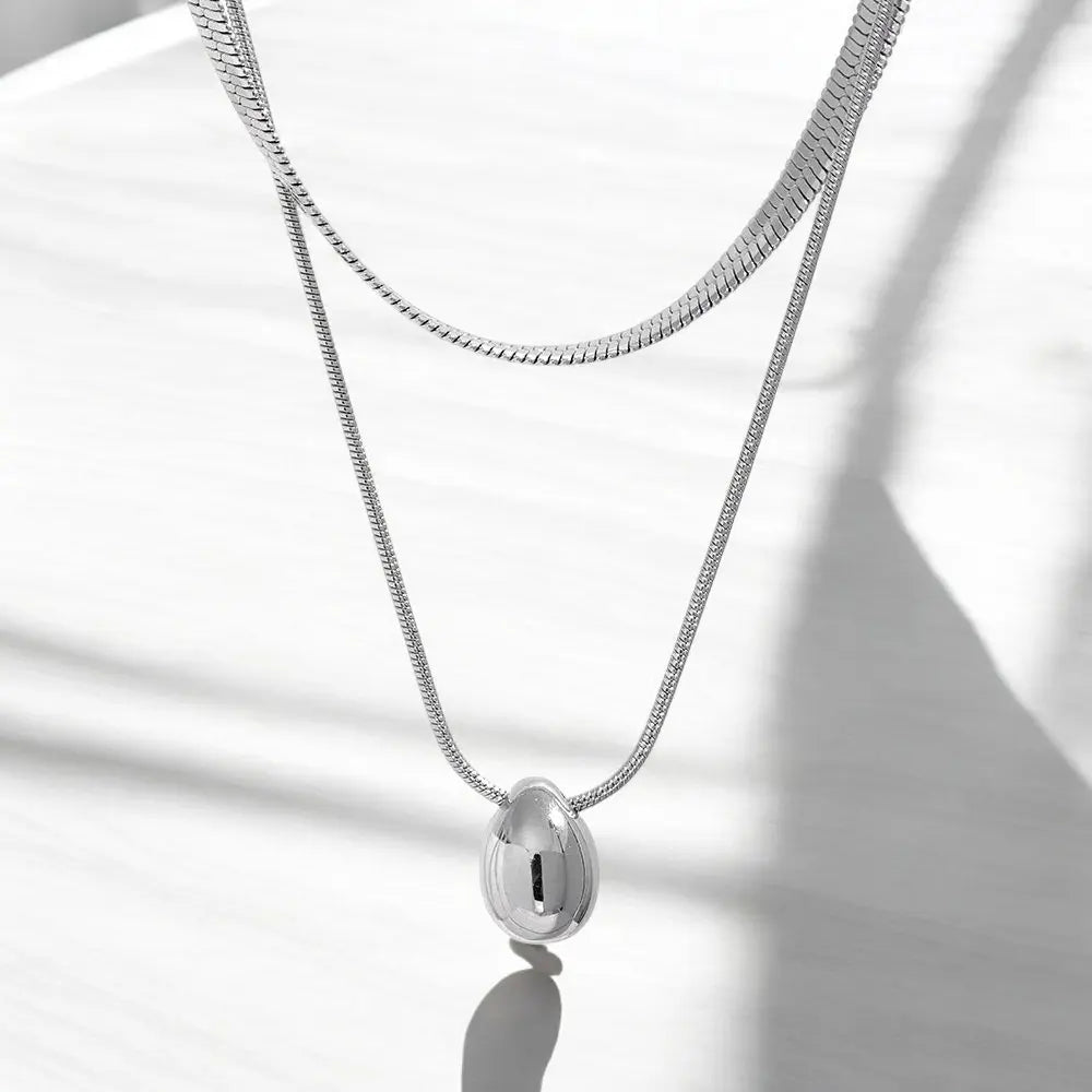 Silver necklace with a pendant on a white background