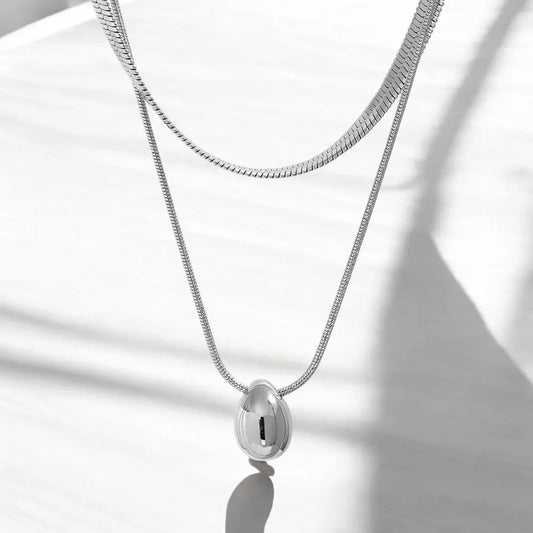 Silver necklace with a pendant on a white background