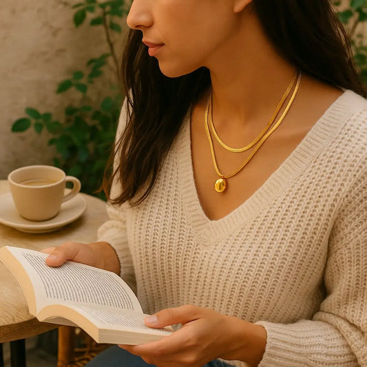 Woman reading a book with a cup of coffee on a table in a cozy setting