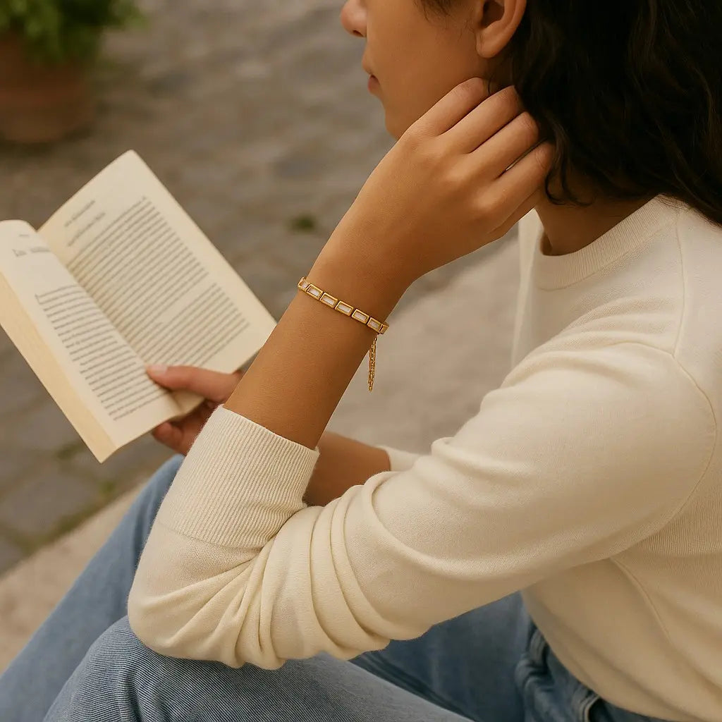 Person reading a book outdoors with a casual setting
