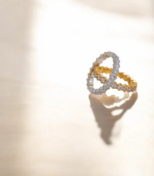 Two interlocking ring designs on a light beige background