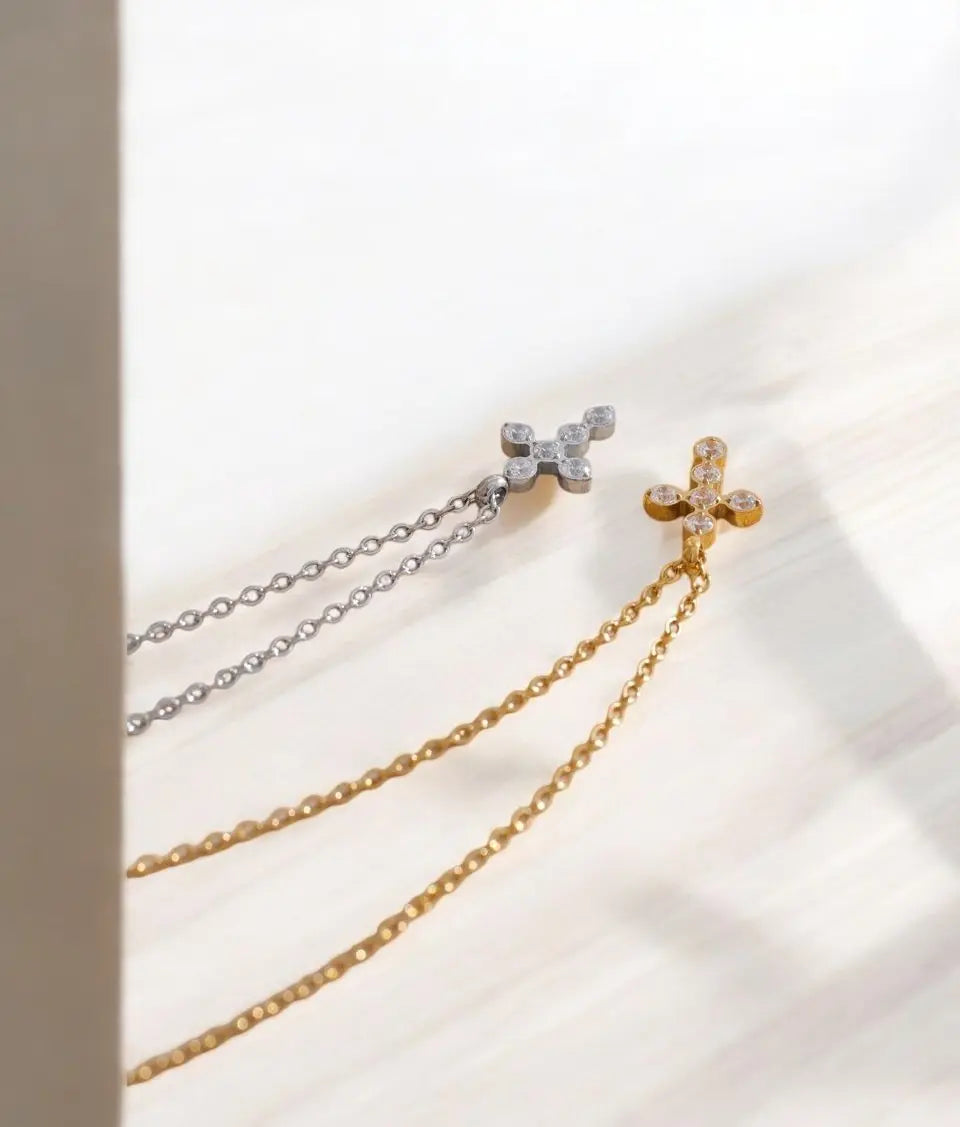 Two gold and silver chain necklaces on a light background