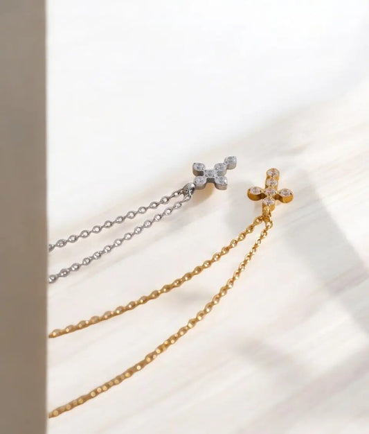 Two gold and silver chain necklaces on a light background