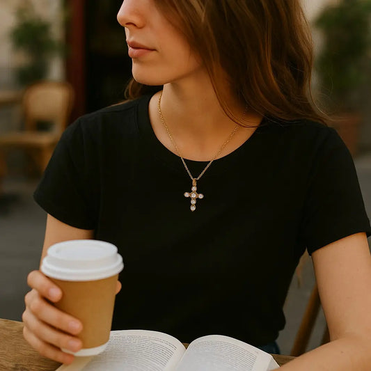 Woman holding a coffee cup and an open book outdoors