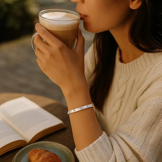 Person holding a cup of coffee with a blurred background