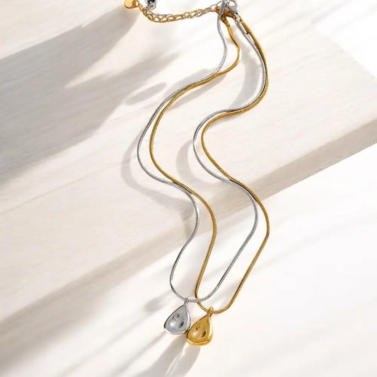 Gold and silver necklaces on a light background