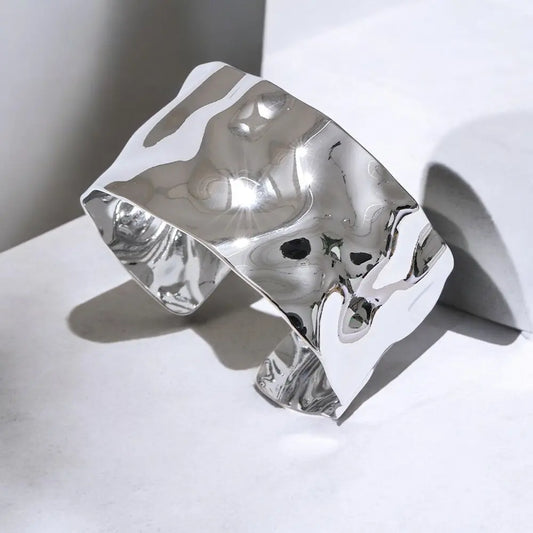 Silver ring with a unique design on a white surface