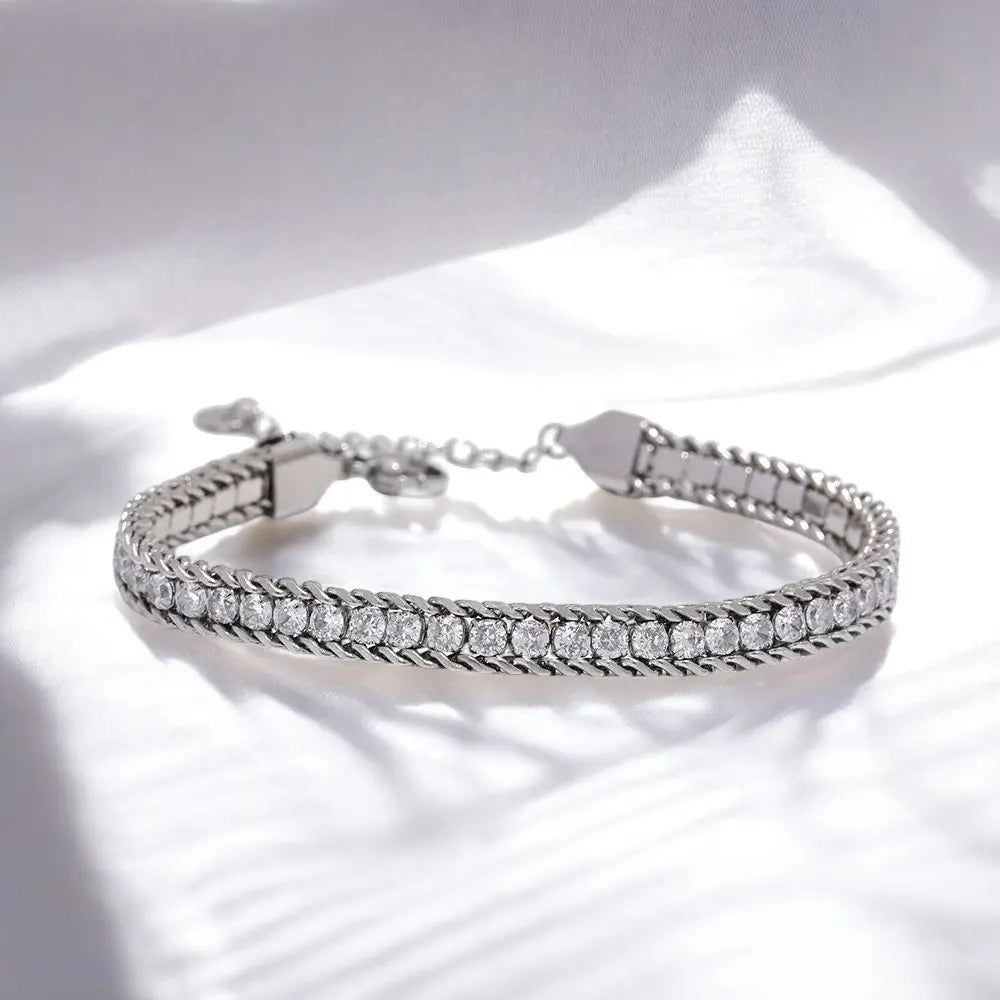 Silver bracelet with clear stones on a white background