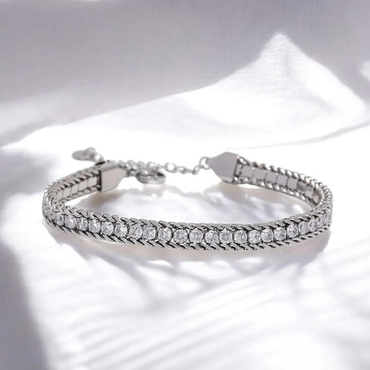 Silver bracelet with clear stones on a white background