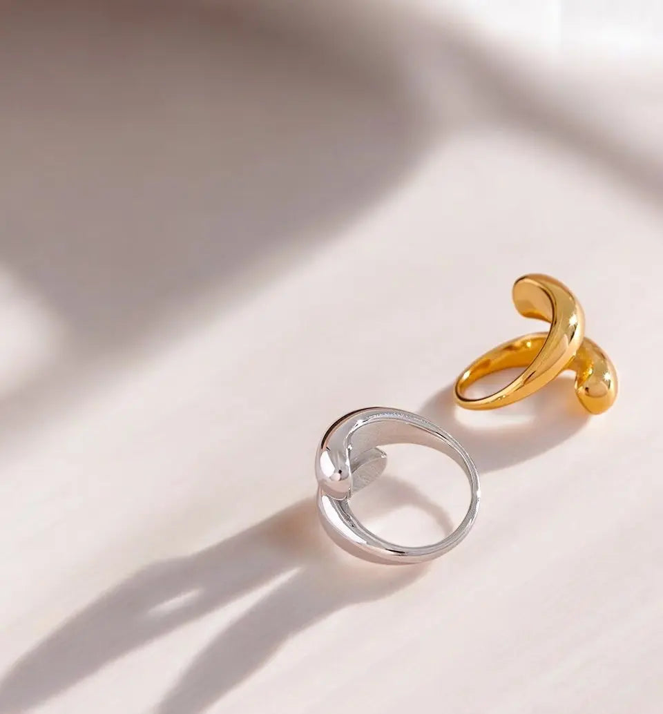 Gold and silver rings on a light pink background
