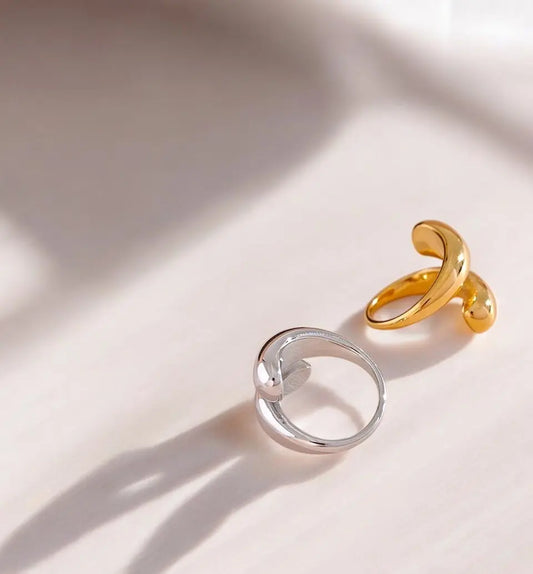 Gold and silver rings on a light pink background