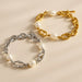 Two pearl and chain bracelets, one gold and one silver, on a beige background.