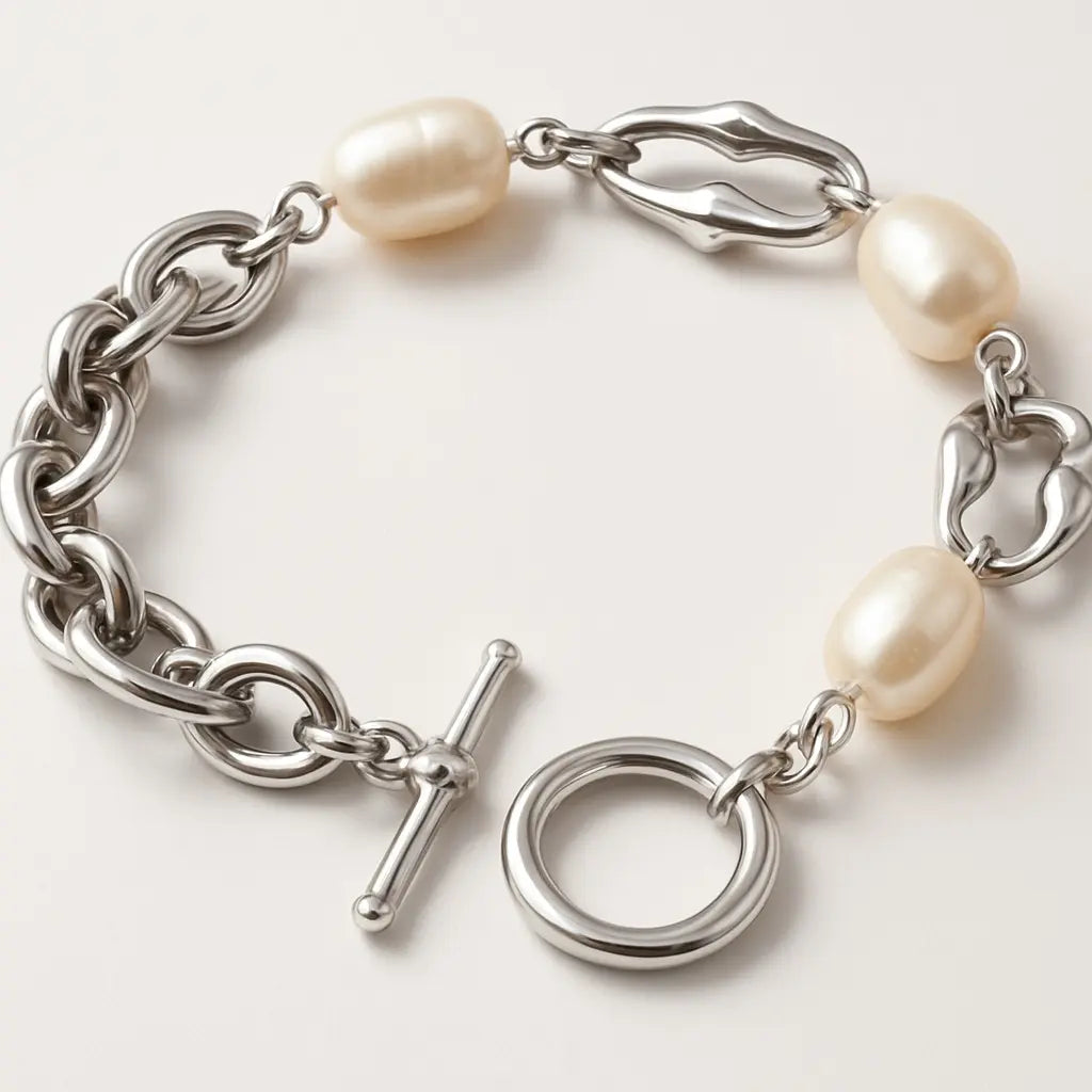 Silver chain bracelet with pearls on a white background