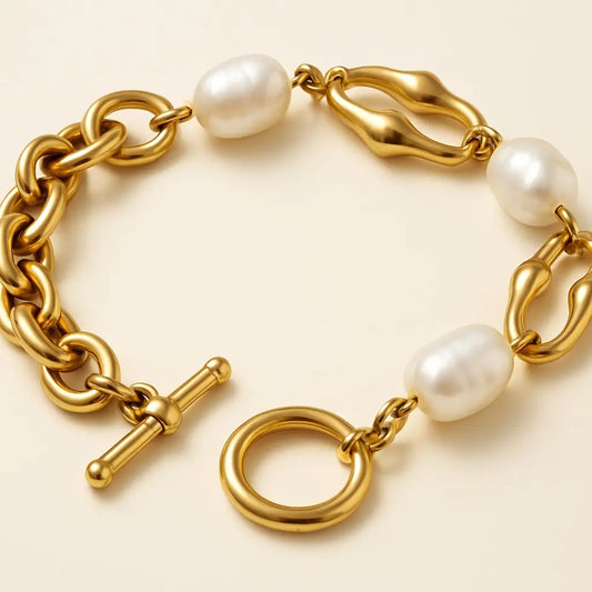 Gold bracelet with pearls on a beige background