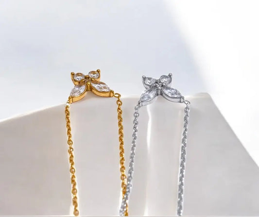 Gold and silver butterfly-shaped earrings on a white background