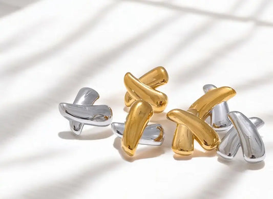 Pair of gold and silver cufflinks on a light background
