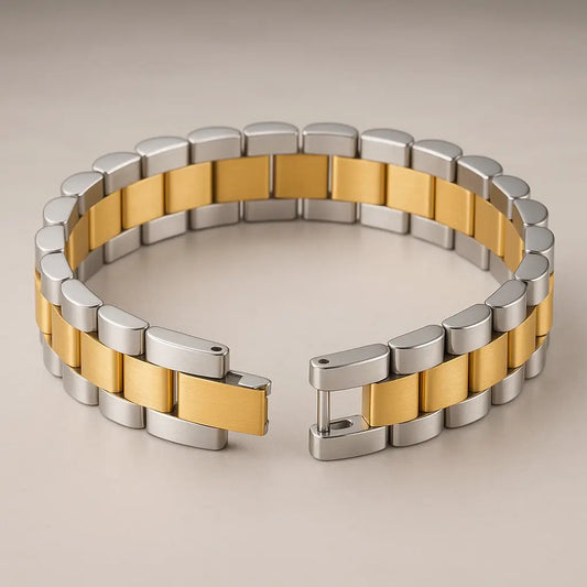 Two-tone silver and gold bracelet on a beige background